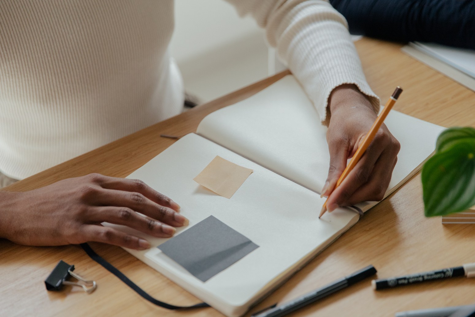 Designer sketching plans in a notebook